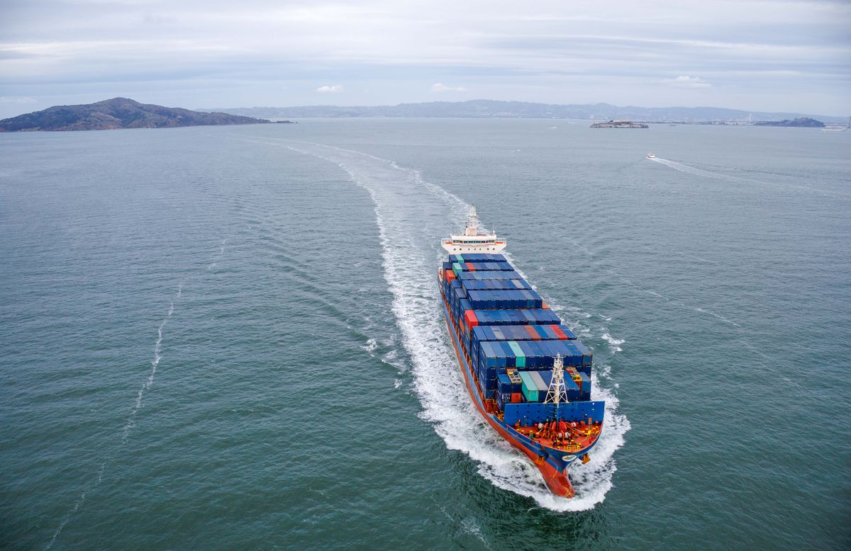 Aerial view of a container ship crossing open ocean water