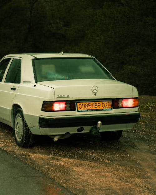 

A White Mercedes Benz Car Parked by the Road