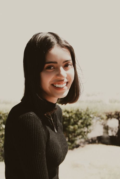 Free Portrait of a smiling woman in a black sweater outdoors in Pachuca de Soto, Mexico. Stock Photo