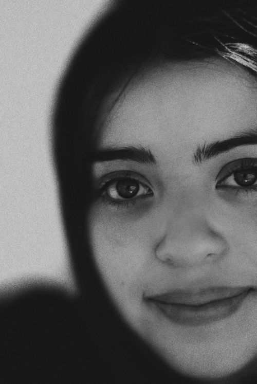 Free Close-up monochrome portrait of a smiling woman with detailed facial features. Stock Photo