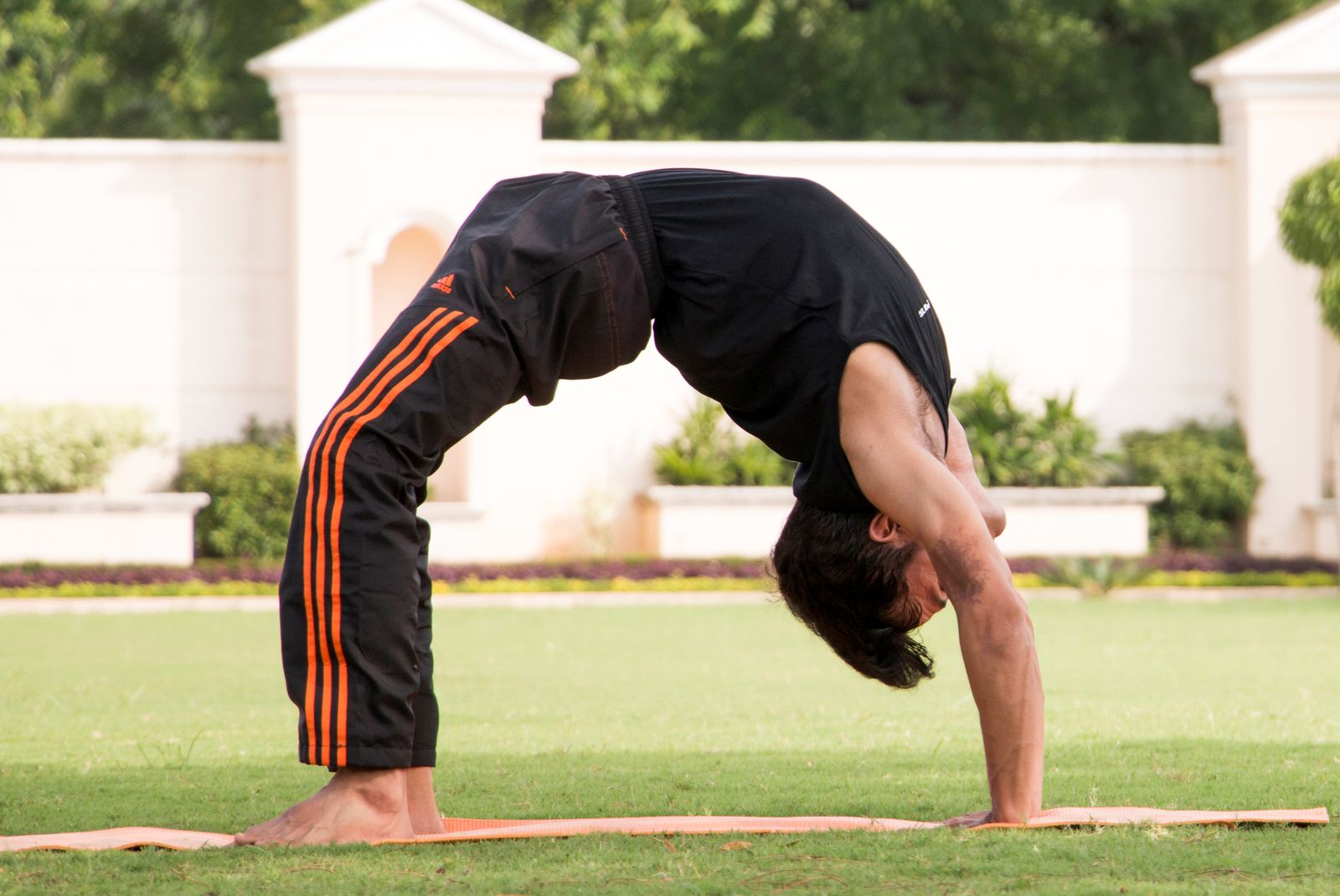Person stretching their torso outdoors in bright daylight