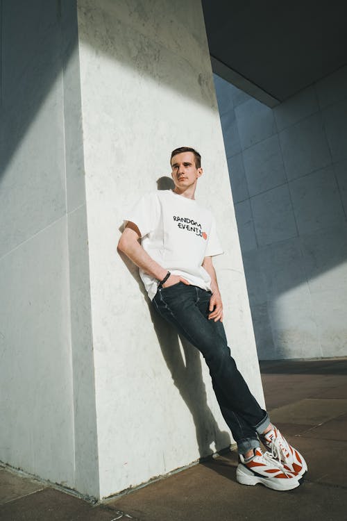 Foto profissional grátis de apoiando, calças jeans, camisa branca