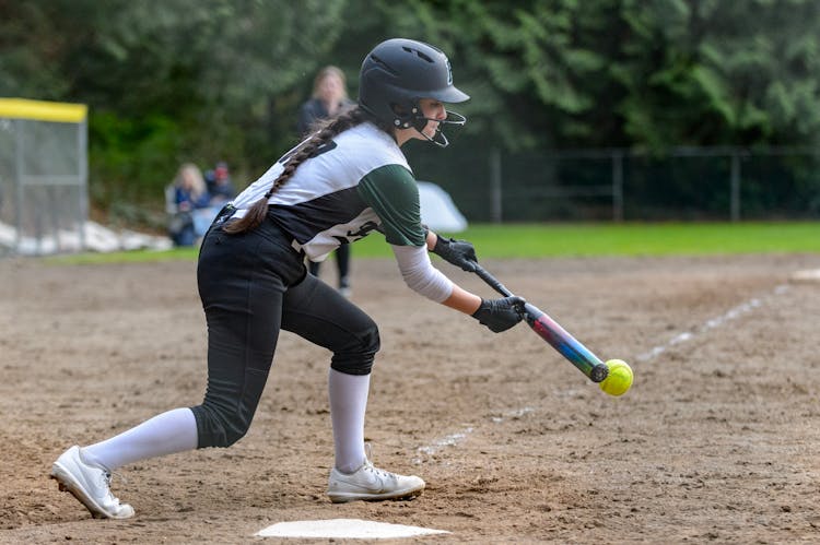 A Woman At Bat Playing Baseball