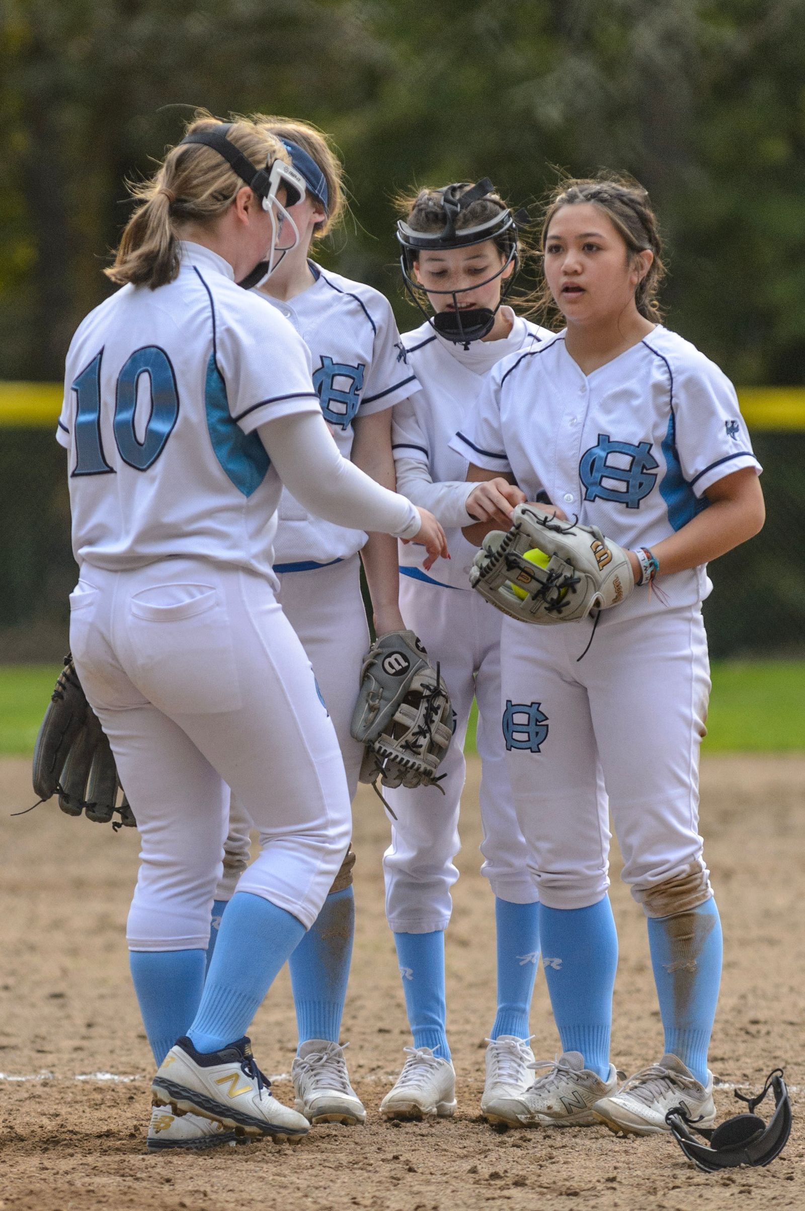 Softball players meeting together on the field