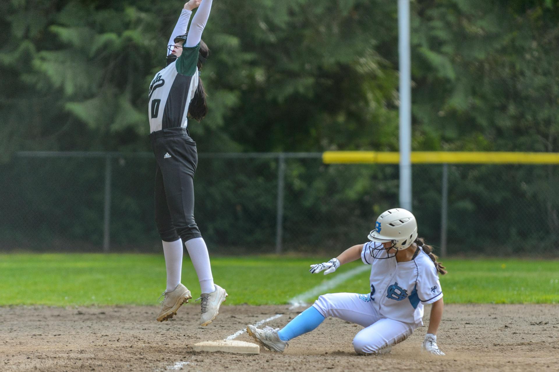 Female softball players in action at a recruiting camp