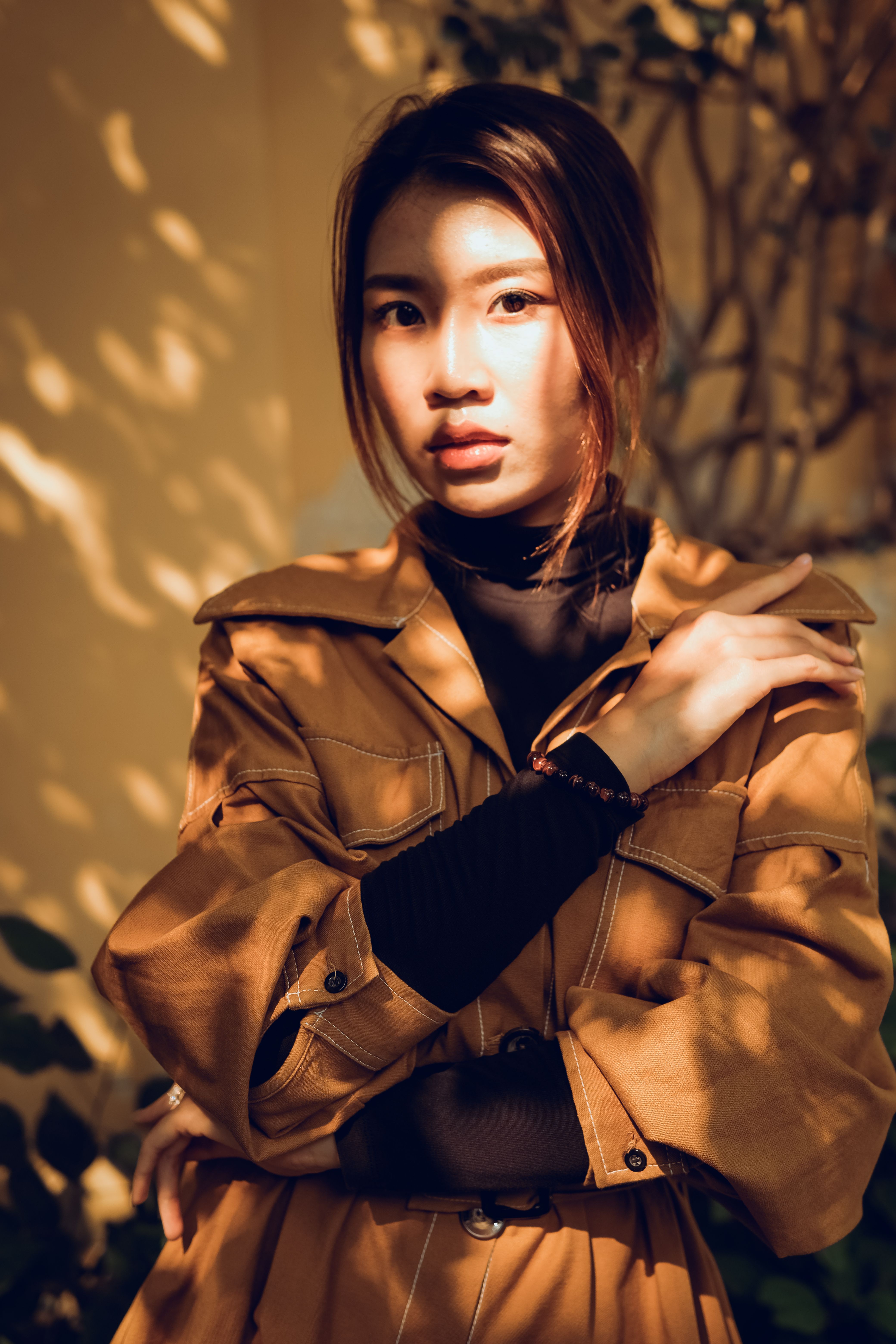 A Woman Wearing a Brown Coat and Cap · Free Stock Photo