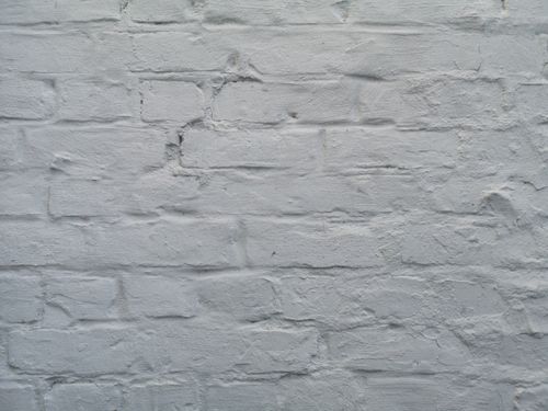 Free Close-up view of a textured white brick wall, ideal for backgrounds and design projects. Stock Photo