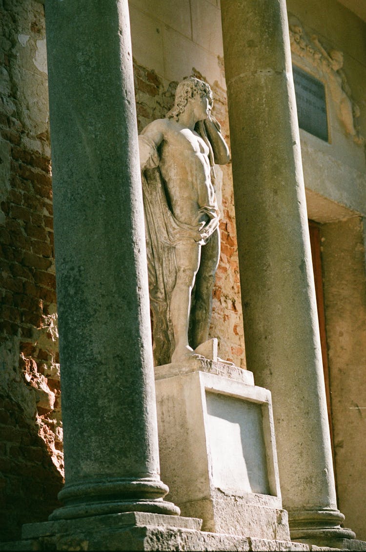 Low Angle Shot Of A Statue By The Building