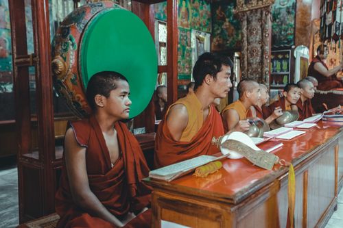 Free Buddhist monks engage in a classroom setting inside a vibrant monastery. Stock Photo
