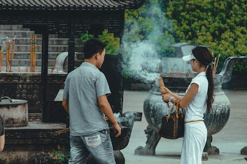 A Woman Holding Burning Incense Sticks