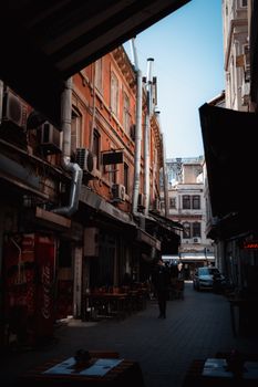 Explore a picturesque narrow alleyway lined with vintage buildings in a historic district.