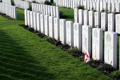 Free Rows of white headstones in a military cemetery on a sunny day, symbolizing remembrance. Stock Photo