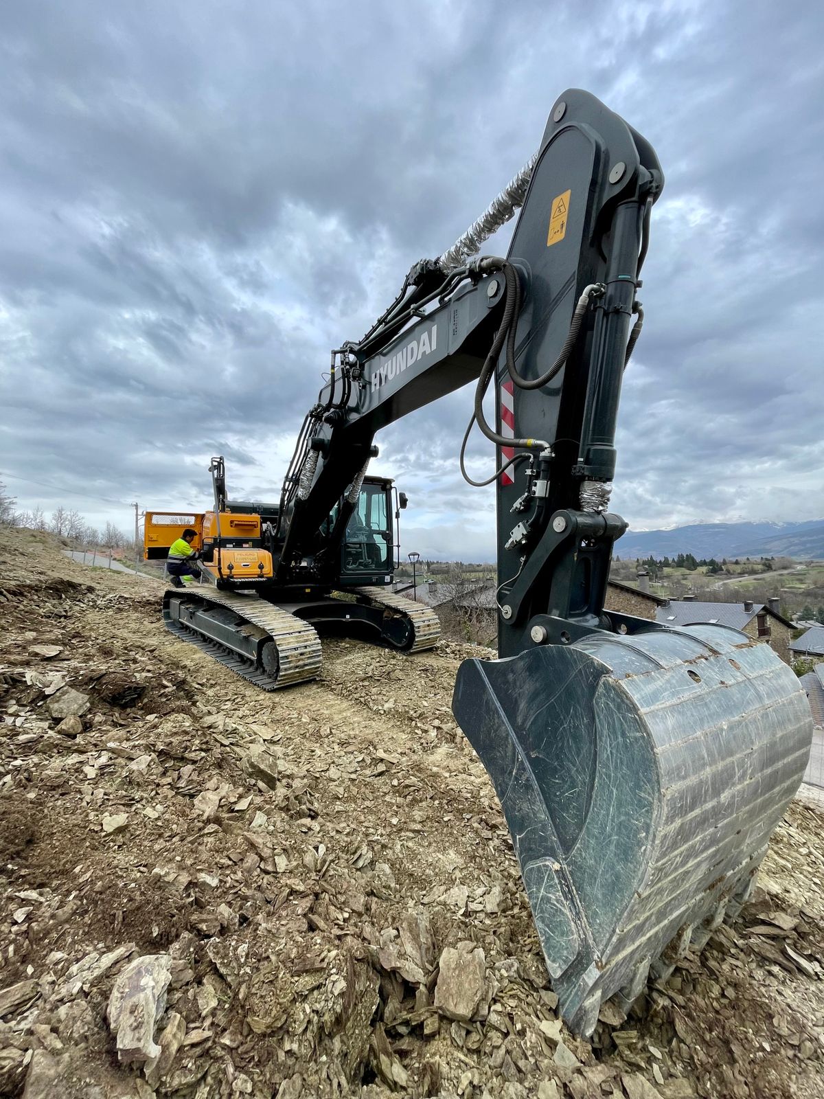 Excavator digging a trench on a residential block