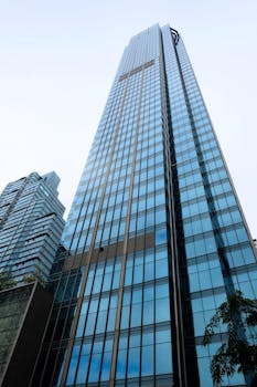 Low angle view of a glass skyscraper in Taguig, showcasing modern architecture.