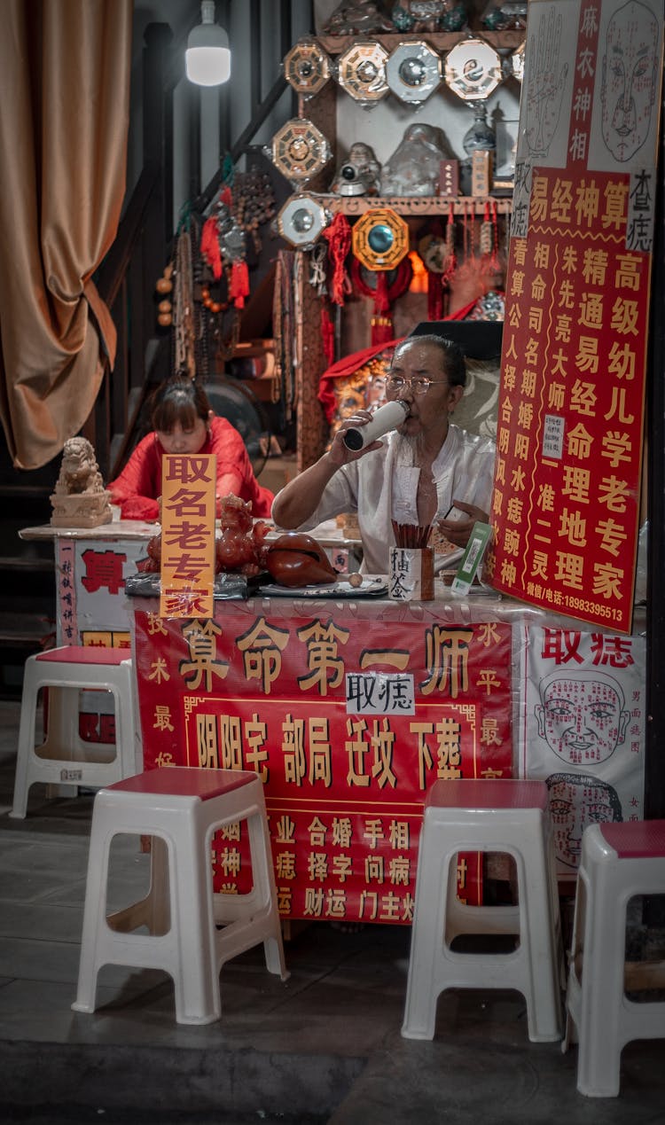 A Fortune Teller Sitting Behind A Desk