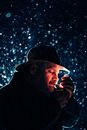 Man in Hat Lighting Cigarette Outdoors in Winter