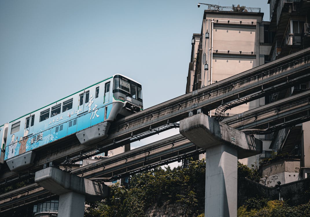 Blue and White Train on Rail Tracks