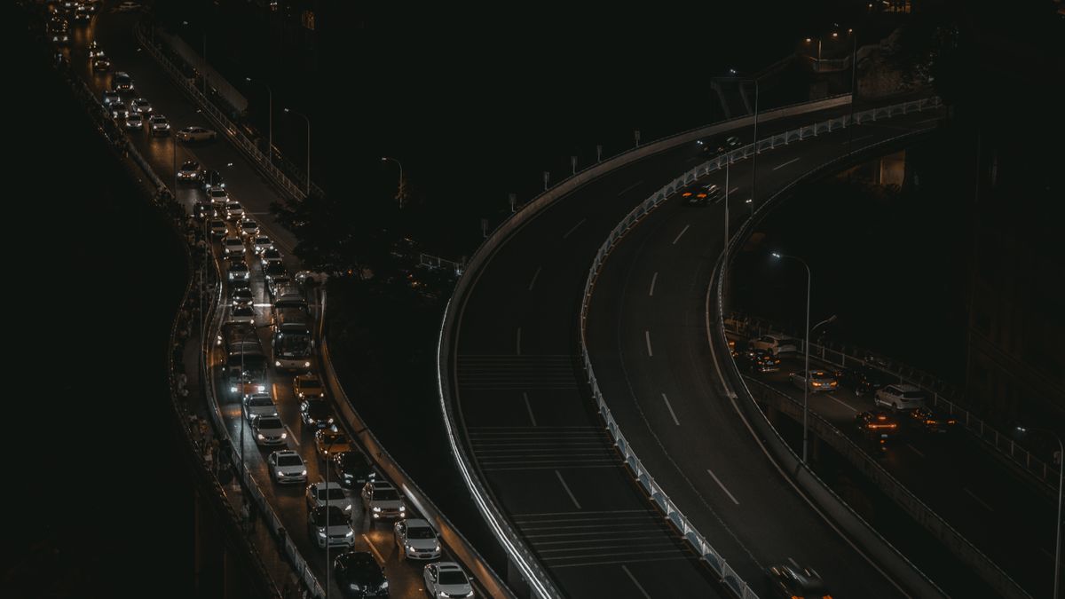 An aerial view capturing the bustling night traffic on Chongqing's highways.