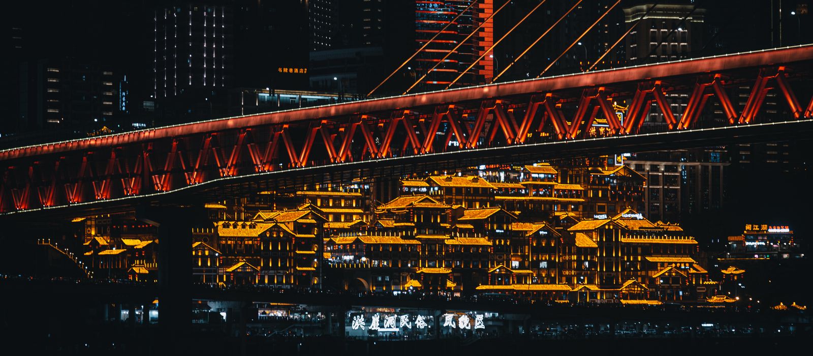 Stunning night scene of Chongqing's illuminated skyline featuring Qiansimen Bridge. — flights from Tianjin to Chongqing
