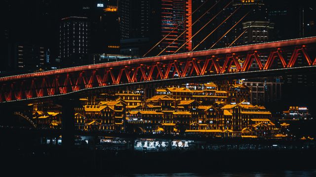 Stunning night scene of Chongqing's illuminated skyline featuring Qiansimen Bridge. — lounges at Chongqing Airport