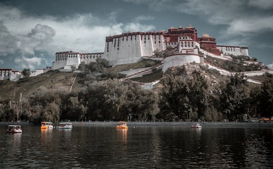 Breathtaking view of Potala Palace in Tibet with a tranquil lake in the foreground, perfect for travel inspiration.