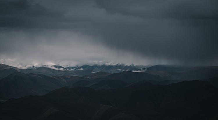 Scenic View Of Dark Clouds Above The Mountains