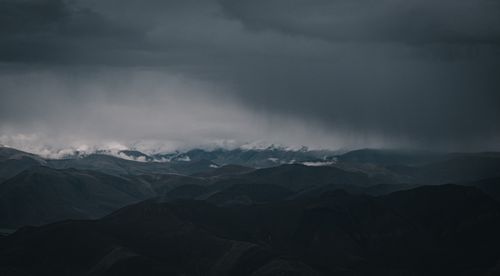 Free Explore the moody, dark clouds over the majestic Tibetan mountainscape in China. Stock Photo