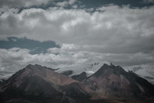 Free A majestic view of Tibetan mountains under dynamic cloud formations, showcasing natural beauty and serenity. Stock Photo