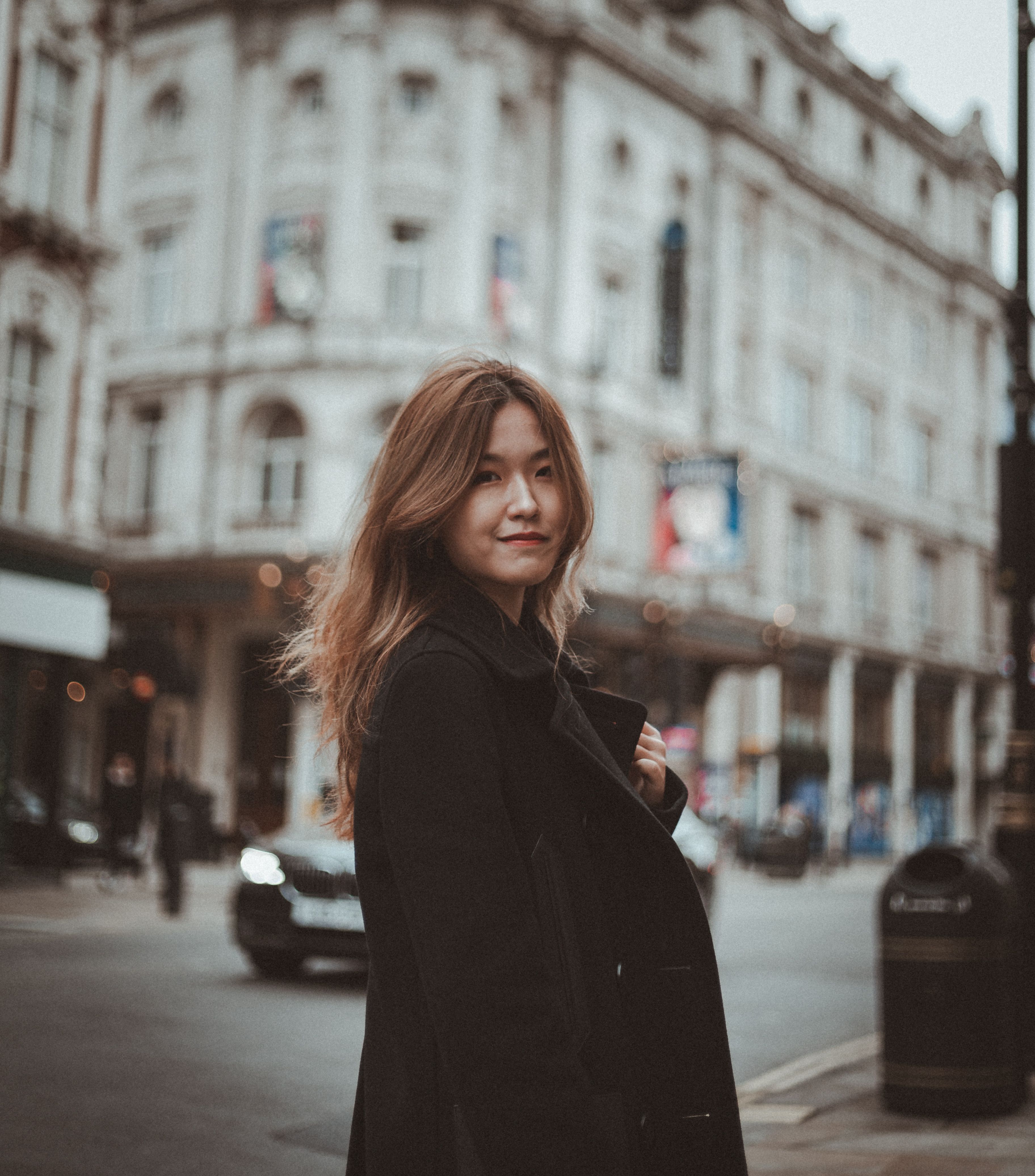 A Woman in Black Coat Standing on the Sidewalk · Free Stock Photo