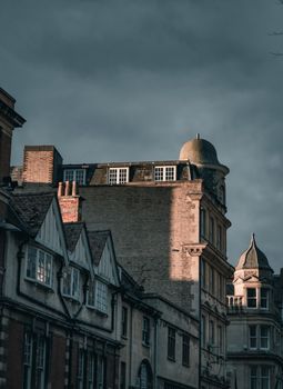 View of historic buildings under a moody sky in Oxford, highlighting classic architecture.