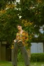 A Woman Posing while Standing Under the Tree