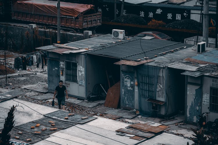 Man Walking By Abandoned Houses After An Earthquake