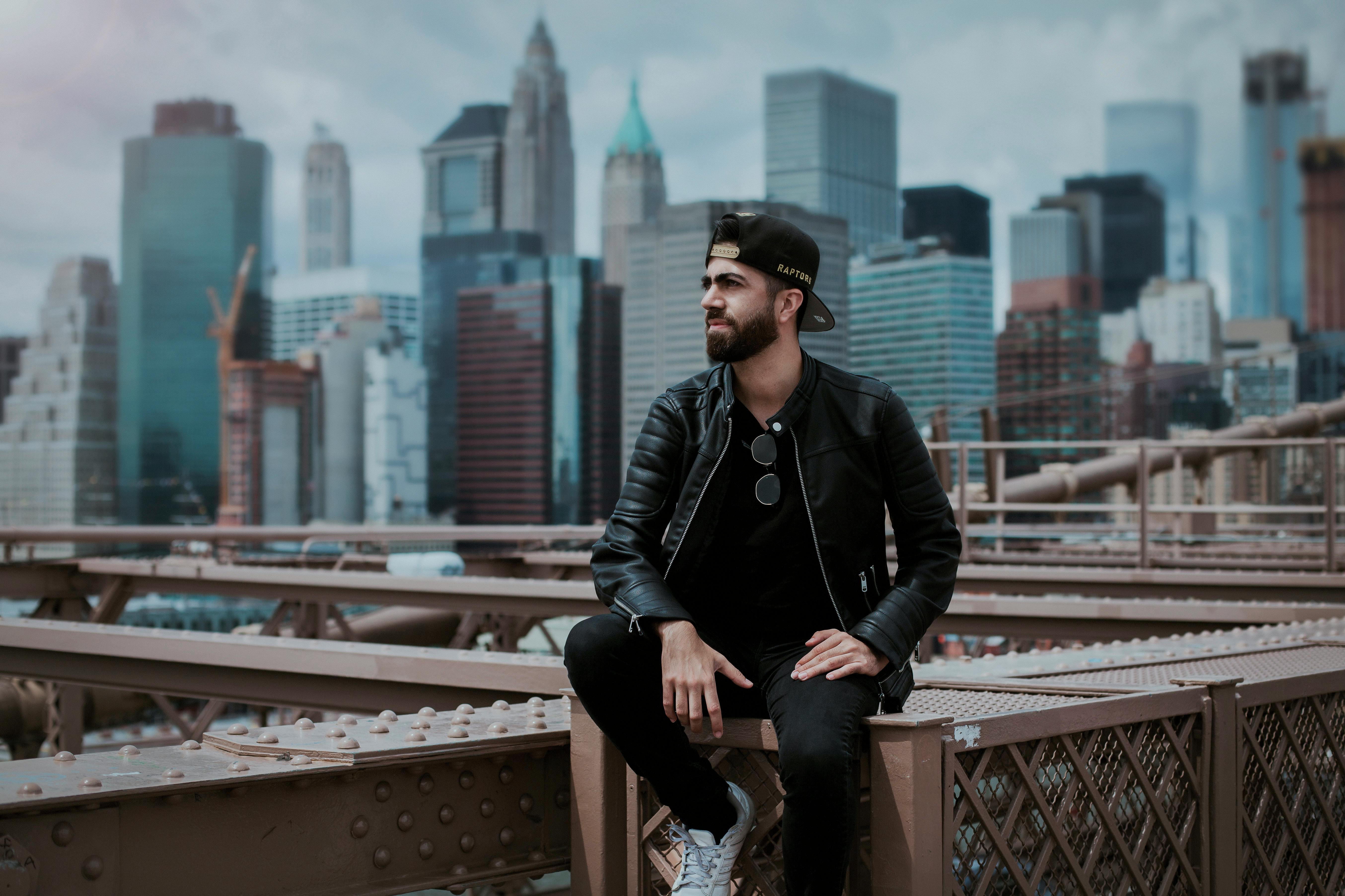 man wearing black zip up leather jacket