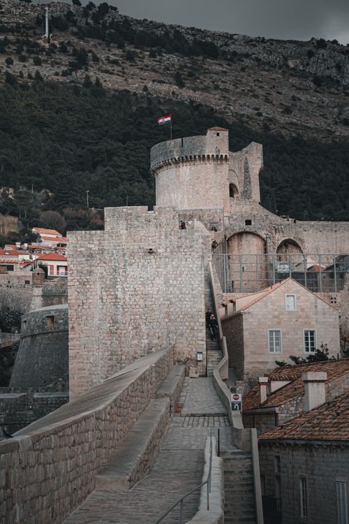 Free Explore the historic stone fortress with a tower and Croatian flag in Dubrovnik, Croatia. Stock Photo