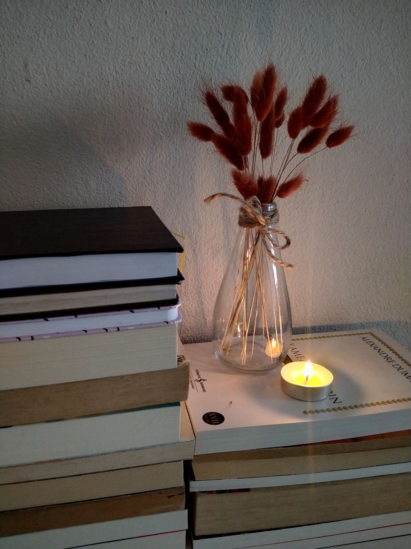 Stack of books with a candle