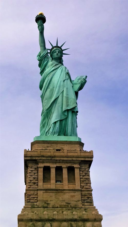 Free Low angle shot of the Statue of Liberty against a cloudy sky in New York, USA. Stock Photo