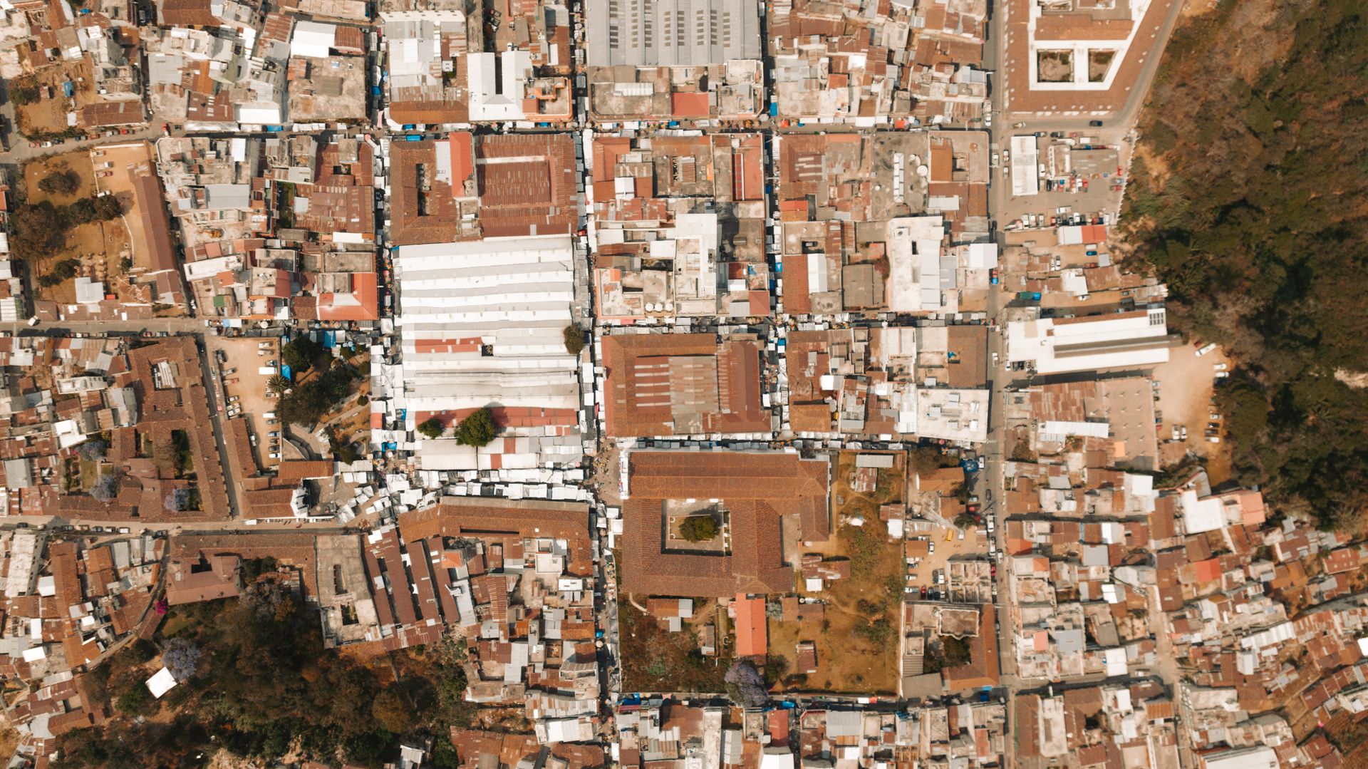 Top-down aerial photo capturing the intricate layout of town rooftops and streets.
