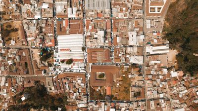 Top-down aerial of tiled rooftops and narrow streets — K on Pexels
