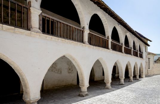 Explore the arched facades of a historical monastery in Cyprus, showcasing ancient architecture.