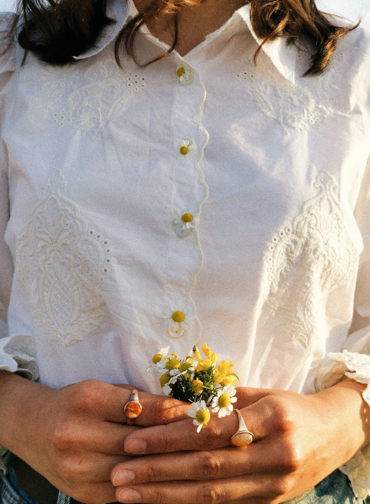 Woman Holding Daisies In Her Hands