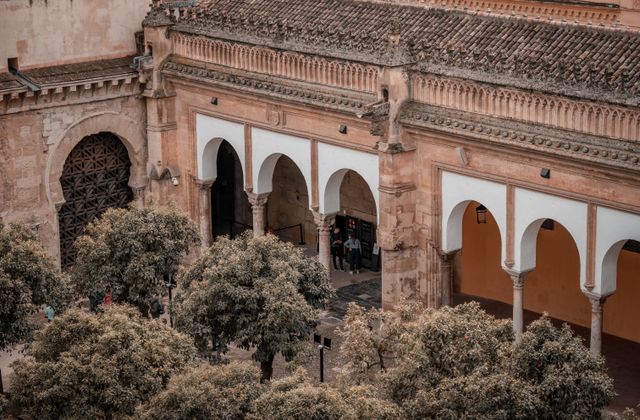 Aerial view of the historic Mosque-Cathedral of Córdoba with its iconic arches and surrounding trees. — arriving in Córdoba