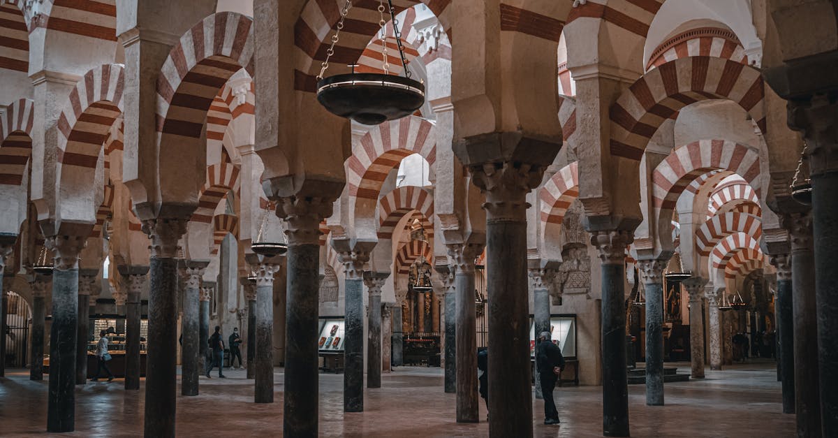 Explore the historic Mosque-Cathedral of Córdoba's stunning arches and columns in this captivating interior view.