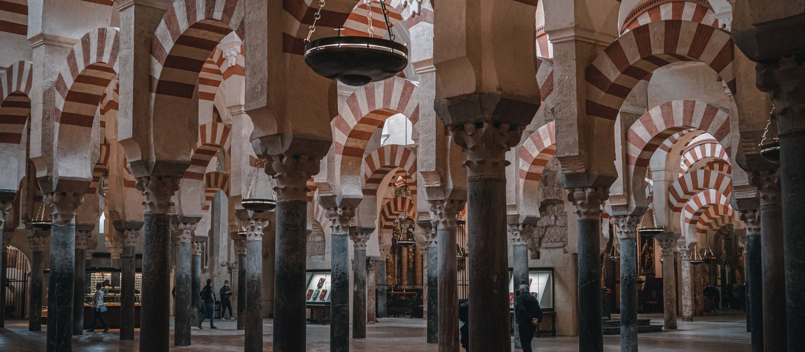 Explore the historic Mosque-Cathedral of Córdoba's stunning arches and columns in this captivating interior view.