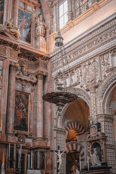 Intricately detailed baroque architecture inside Cordoba Cathedral, emphasizing religious art and spirituality.