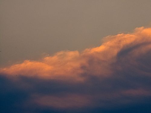 Free Capture of moody clouds at sunset with a warm glow evoking tranquility. Stock Photo