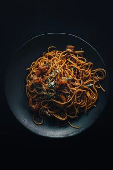A delicious plate of spaghetti pasta topped with shrimp and garnished, perfect for gourmet food scenes.