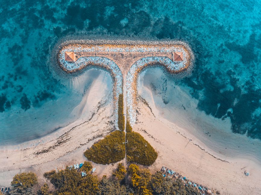 Stunning aerial view of a sandy beach with a unique pathway in Marga, Bali, Indonesia.