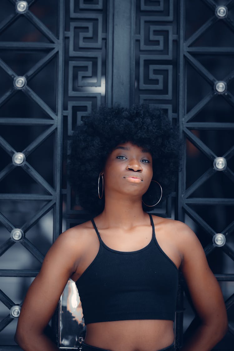 Woman In Black Crop Top Leaning On A Gate