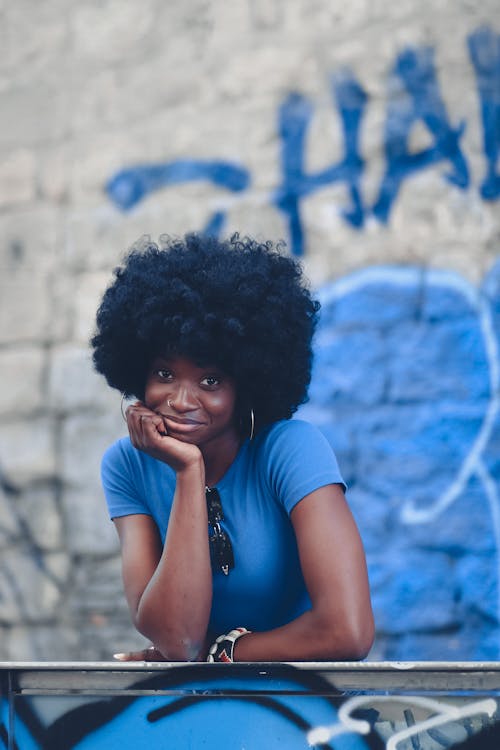 Smiling Woman Leaning on a Railing with her Chin on her Hand