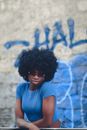 Woman in Blue Crop Top Leaning on a Railing